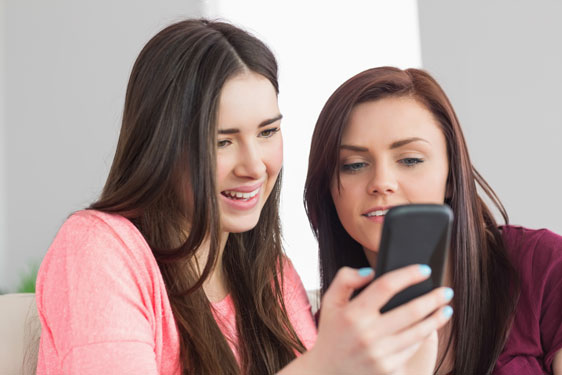 teenagers on mobile phone